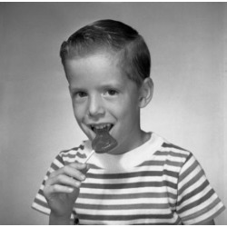 Posterazzi SAL255420927 Studio Portrait of Boy Eating Lollipop Poster Print - 18 x 24 in.