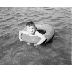 Posterazzi SAL255421877 Boy Swimming in Inflatable Ring Poster Print - 18 x 24 in.