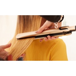 Relaxer or Shampoo, Condition, Blowout, and Flat-Iron, or Extensions at Glitz & Glam Beauty Bar (Up to 44% Off)