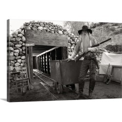 Large Gallery-Wrapped Canvas Wall Art Print 24 x 16 entitled A miner in front of a mine with a gun