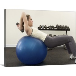 Large Gallery-Wrapped Canvas Wall Art Print 24 x 17 entitled Woman using exercise ball and hand weights