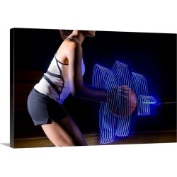 Large Solid-Faced Canvas Print Wall Art Print 30 x 20 entitled Female basketball player holding ball with surrounding ligh...