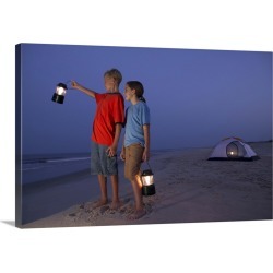 Large Solid-Faced Canvas Print Wall Art Print 30 x 20 entitled A boy and a girl stand with lanterns on the beach with a te...