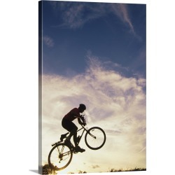 Large Gallery-Wrapped Canvas Wall Art Print 16 x 24 entitled Silhouette of man in mid-air on mountain bike
